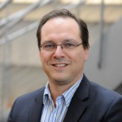 Photo of Eric Neumann, PhD, Co-founder and Chief Knowledge and Intelligence Officer (CKIO), IQUrium